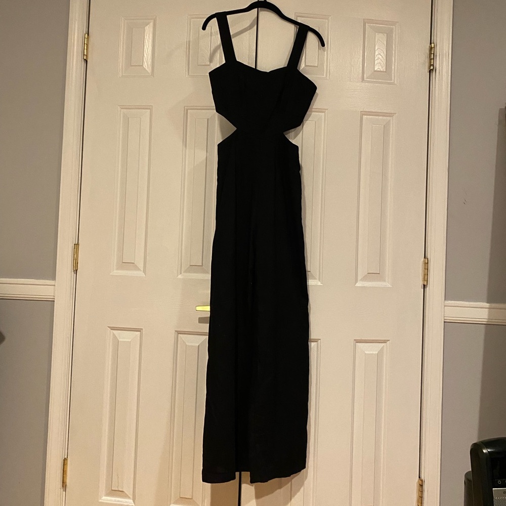 Black zip up jumpsuit with cutout on sides